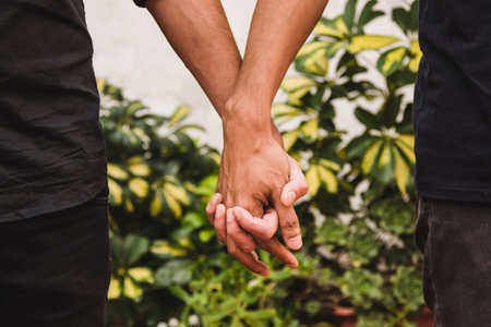 men holding hands near plants. High quality photoの写真素材