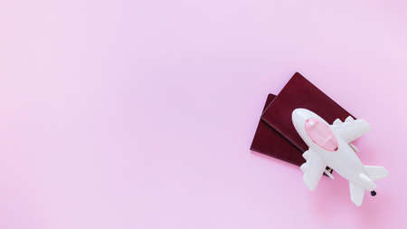 high angle view airplane passport pink surface. High quality photoの写真素材