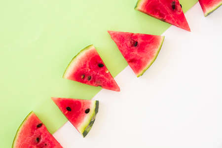 triangular shape watermelon slices dual background. High quality photoの写真素材