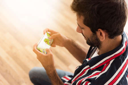 top view man playing mobile games. High quality photoの写真素材