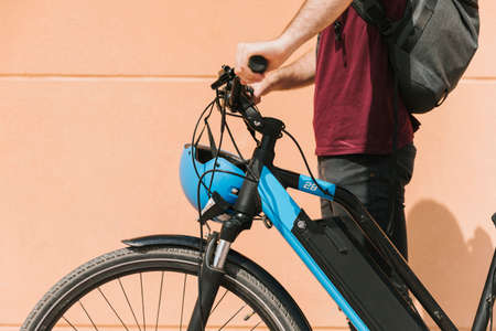 sideways cyclist standing e bike. High quality photoの写真素材
