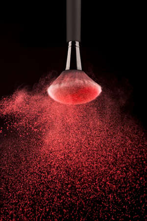 upside down makeup brush red powder splash. High quality photoの写真素材