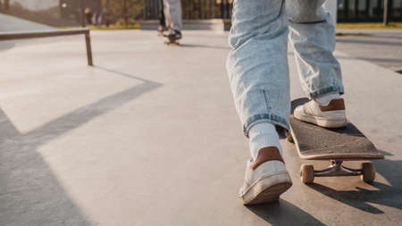 back view teenager with skateboard copy space skatepark. High quality photoの写真素材
