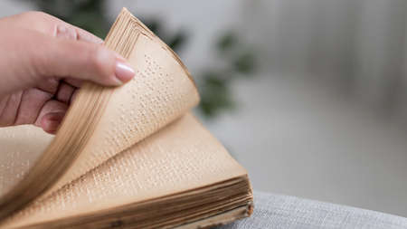 close up hand holding old braille book. High quality photoの写真素材