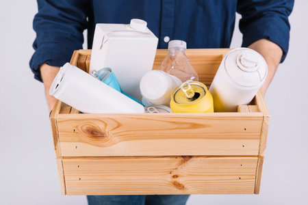 man s hand wooden box full bottles tin cans. High quality photoの写真素材