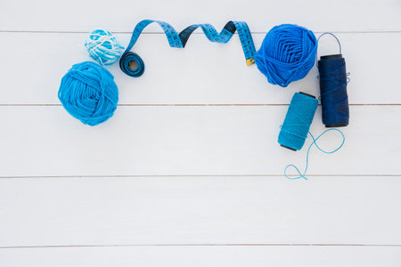blue wool ball measuring tape spool yarn wooden desk. High quality photoの写真素材