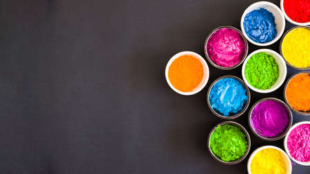 overhead view bowls color holi powder black backdrop. High quality photoの写真素材