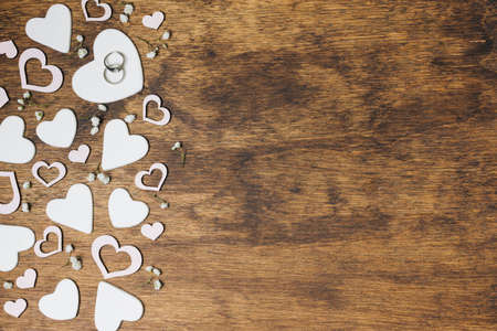 overhead view silver wedding rings heart shape wooden backdrop. High quality photoの写真素材