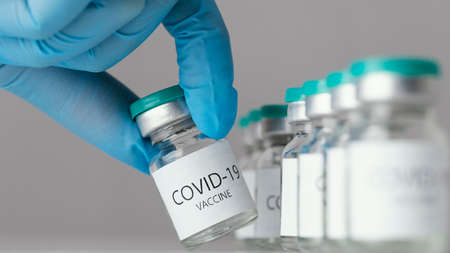doctor holding covid 19 vaccine bottle. High quality photo