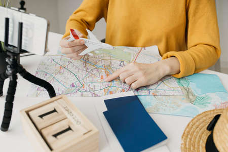 female blogger streaming travel plan online smartphone. High quality photo