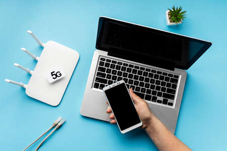top view wi fi router with laptop hand holding smartphone. High quality photoの写真素材
