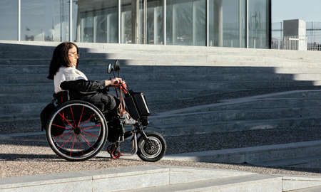 side view woman wheelchair street with copy space. High quality photoの写真素材