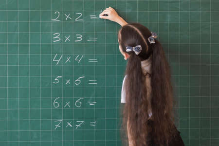 girl making calculations blackboard. High quality photoの写真素材