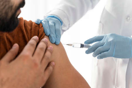 man being vaccinating by doctor close up. High quality photoの写真素材