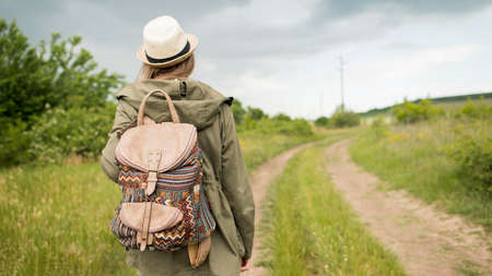 back view traveller hat walking outdoors. High quality photo
