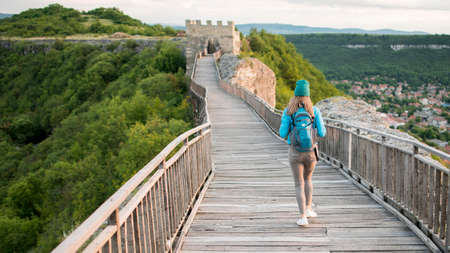 back view traveller walking down bridge. High quality photoの写真素材