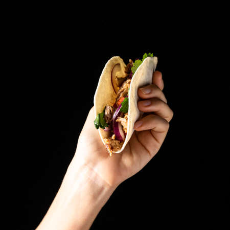 close up hand holding taco with meat. High quality photoの写真素材