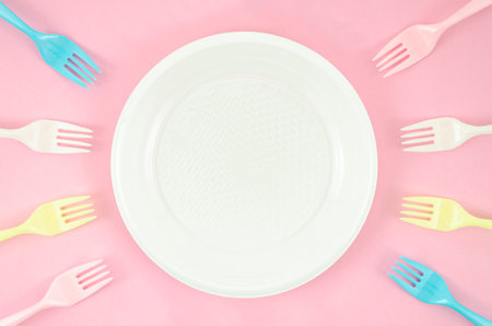colorful plastic dishes pink background. High quality photoの写真素材