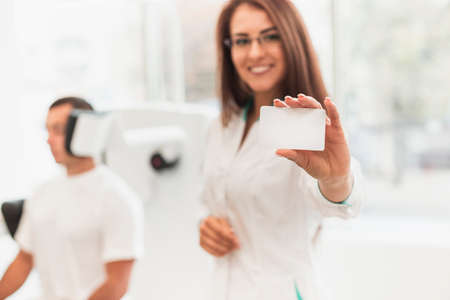 beautiful female doctor showing card mock up. High quality photoの写真素材