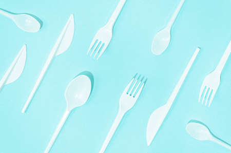 white disposable cutlery composition turquoise background. High quality photoの写真素材