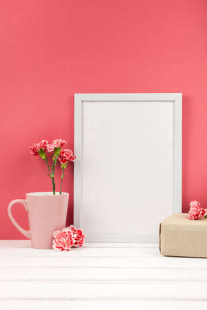 carnation flowers gift box cup white empty frame table. High quality photoの写真素材