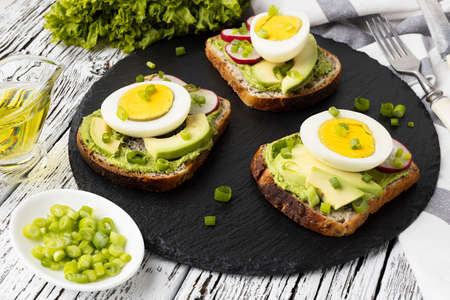 high angle sandwiches slate with egg avocado. High quality photoの写真素材