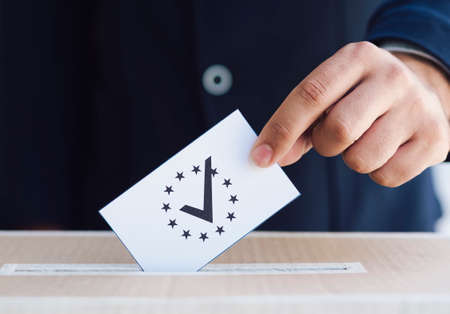 man putting ballot box close up. High quality photoの写真素材