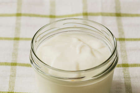 overhead view yogurt open glass jar napkin. High quality photoの写真素材