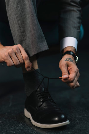 low section businessman s hand tying shoelace. High quality photoの写真素材