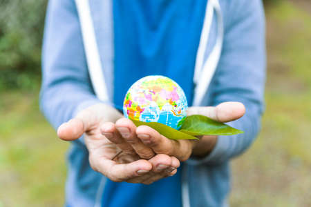 man holding sphere palm hand with leaf. High quality photoの写真素材
