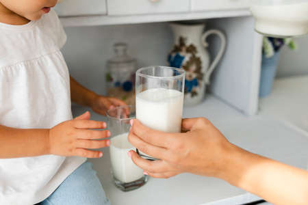 mother hand offering glass milk. High quality photoの写真素材