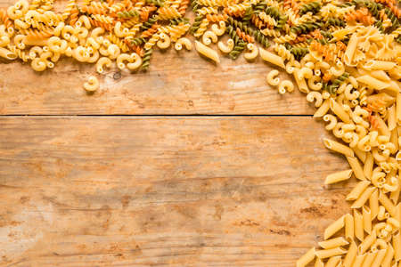 high angle view various types uncooked pasta wooden desk. High quality photoの写真素材