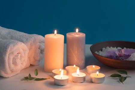 lighted candles rolled up towel bath spa salt table. High quality photoの写真素材