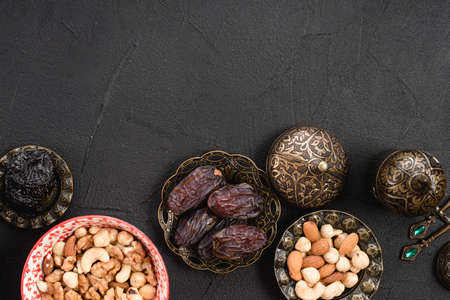 overhead view juicy delicious dates nuts metallic bowl concrete background. High quality photoの写真素材