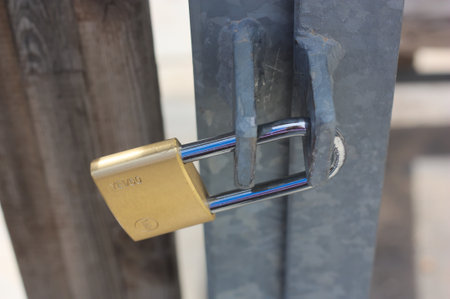 A padlock on metal door on the door in a park.のeditorial素材