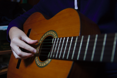 A close-up of a woman rehearsing with the Spanish guitarの写真素材