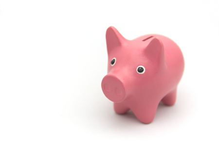 A piggy piggy bank in pink on a white background with room for text on the leftの写真素材