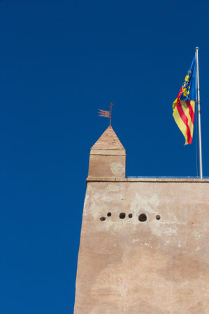 Detail of the top of the tower of the Torrente Castle with the Valencian flag waving in the windのeditorial素材
