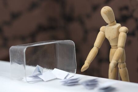 A wooden dummy is taking the votes from the ballot box and counting them
