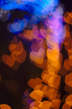 Background image with orange and blue hearts shaped lights on black