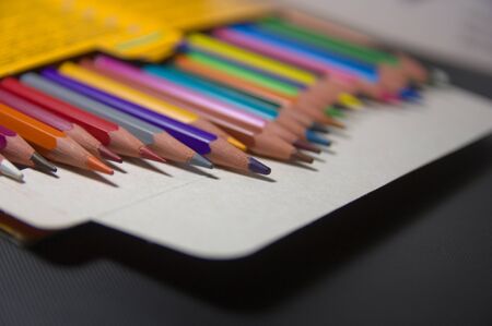 Perspective view of a box of colored pencils that are messy and out of focus creating a space to add texts or graphics. Copy spaceの写真素材