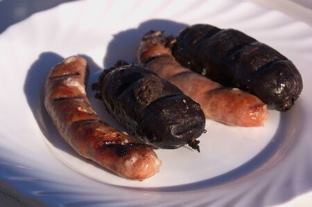 Dish with assorted sausages, black pudding and sausages, grilled during a country barbecueの写真素材