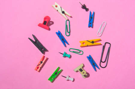 Close-up of a set forming an irregular circle with office supplies such as clips, tweezers,...