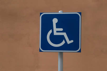 Image of a traffic sign that warns of the existence of a special parking for disabled drivers who use a wheelchairの写真素材