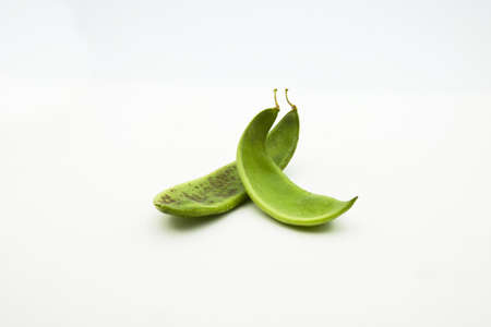 Image on white of some green pods called GarrofÃ³ or Lima bean (Phaseolus lunatus), a typical...