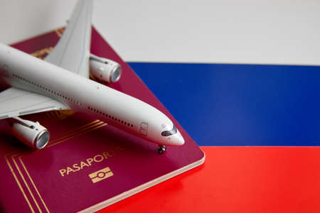 A miniature airplane, a passport of the European community on the colors of the flag of Russiaの写真素材