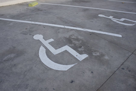 Wheelchair painted on the ground signals the existence of a parking space reserved for disabled...
