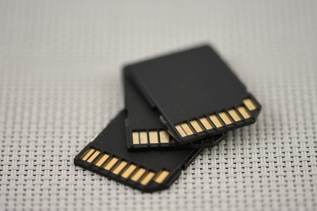 Black microSD memory card and SD card adapter isolated on whiteの写真素材