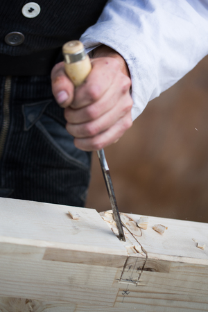 carpenter hands working with a chisel,detail