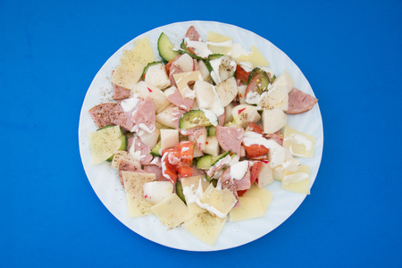 fresh vegetable salad on blue backgroundの写真素材